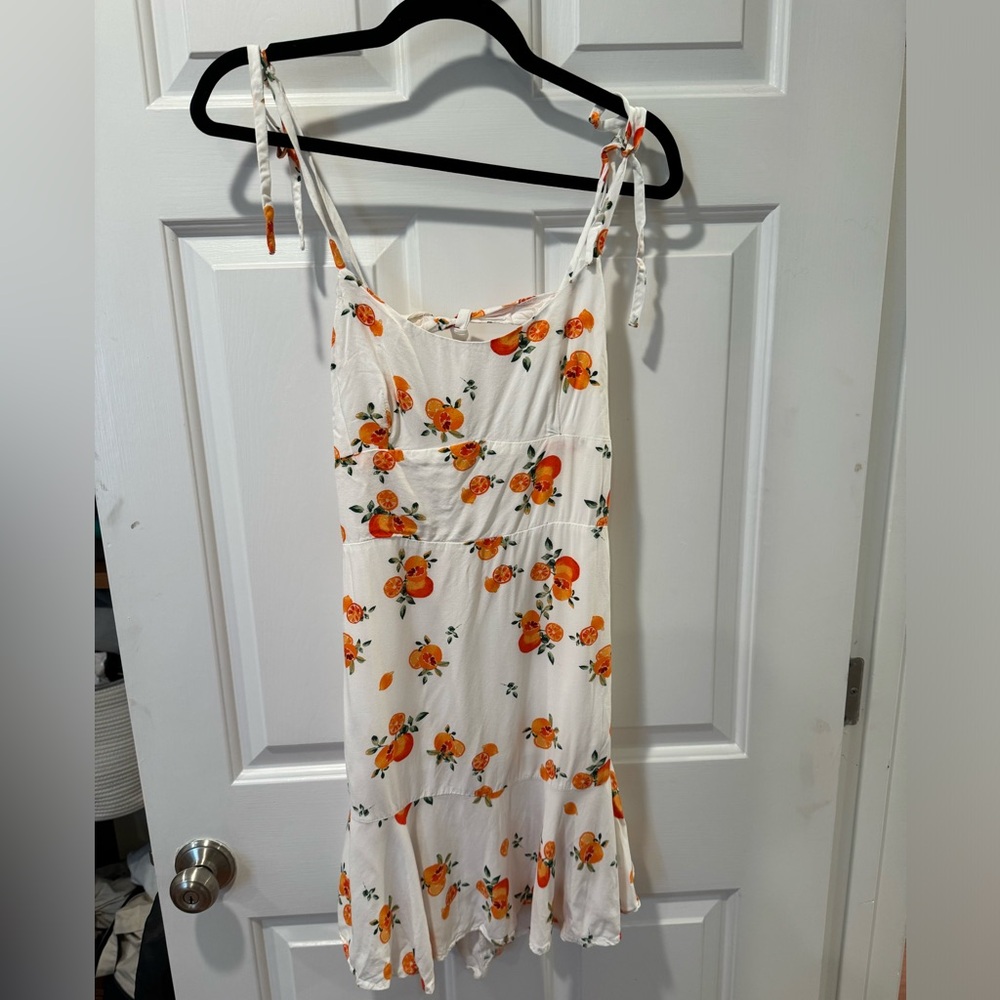 White sun dress with orange pattern